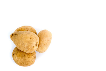 Three fresh potatoes isolated on a white background.
