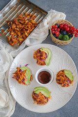 Homemade between meals snack. Vegan Pulled Pork Tortilla Cups with Mixed Fruits Basket. Delicious,...