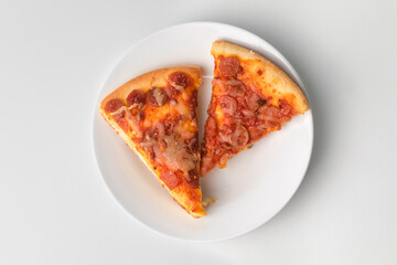 high view of slice pizza on white plate on isolated white background