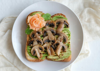 Delicious homemade healthy meal. Avocado Saute Mushroom with Smoked Salmon on Wholemeal Toast. Eaten with strawberry and hard boiled egg, ideal for breakfast, light lunch and dinner