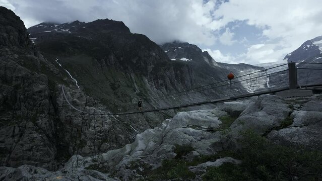 Man hiking Trift bridge switzerland