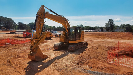 excavator in foreground with dozer and truck on grading site - obrazy, fototapety, plakaty