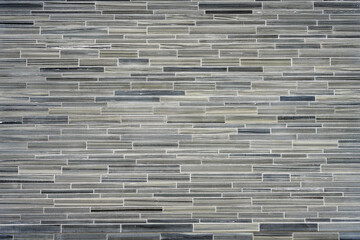 Background from a wall made of small gray granite tiles
