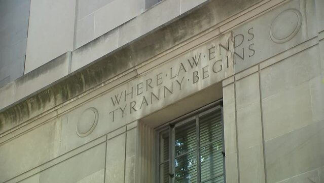 WHERE LAW ENDS TYRANNY BEGINS SIGN ON DOJ DEPARTMENT OF JUSTICE BUILDING