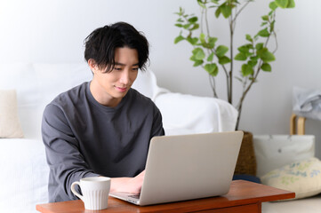 Handsome man playing computer