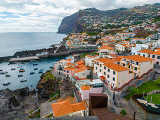 Naklejka na ściany i meble Madeira. Camara de Lobos Aerial View. Small fisherman village with many small boats in a bay. Madeira Island, Portugal.