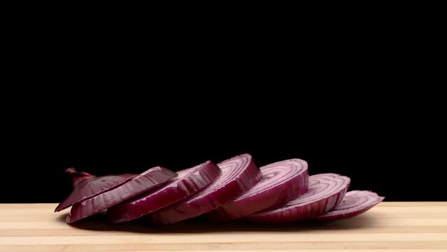 Whirling red onion is chopped. Stop motion animation.