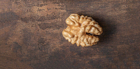 Peeled Walnut on dark vintage table top view. Fresh Walnut kernels, copyspace