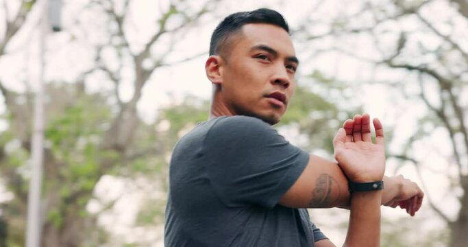 Fitness, health and stretching arm with runner for exercise, sports and workout in neighborhood park. Motivation, muscle and training with man running for health, wellness and cardio in the morning