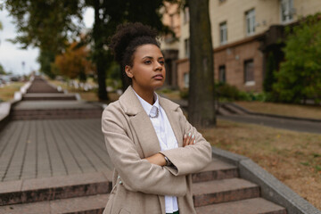 young successful black woman entrepreneur in business clothes on the background of the city stairs. Concept of career growth.