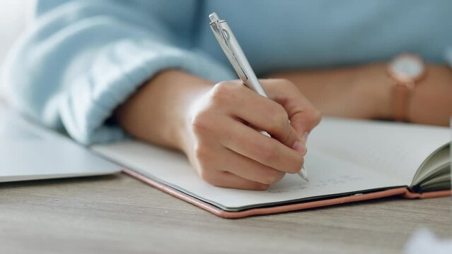 Hands, writing and book of woman with a pen in study journal, diary or notebook at home. Hand of a creative female writer on paper plan, idea or reminder for business goals on table or desk