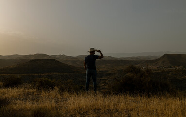 Silhouette of adult man standing on desert during sunset. Almeria, Spain