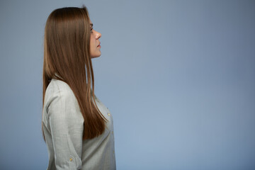 Serious business woman in gray shirt profile portrait. Isolated female portrait on blue background