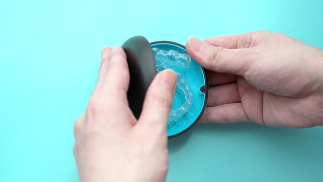 Open the case containing the orthodontic clear aligners for teeth. slow motion video.