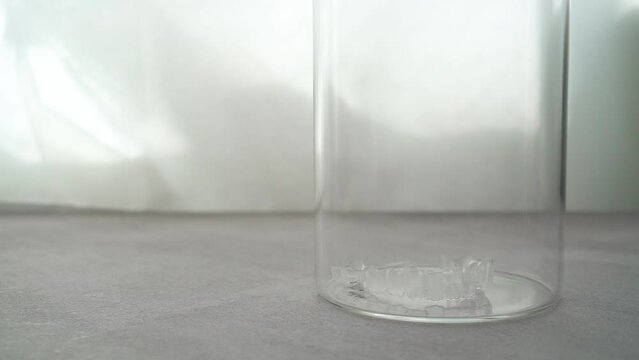 Cleaning orthodontic clear aligners for teeth. slow motion video.