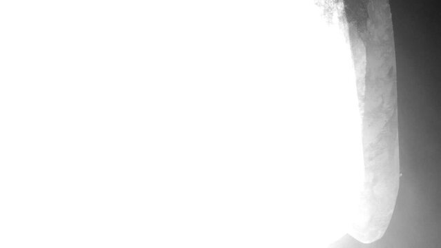 White spinning brush stroke right to left then left to right transition from black background. Track matte alpha channel transition or overlay