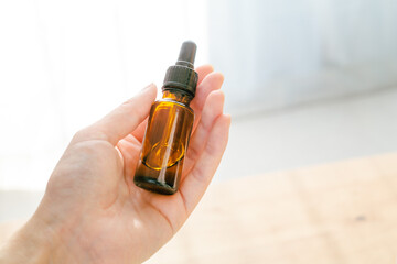 skin oil bottle in hand
