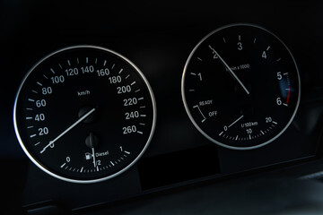 Tachometer or revolution counter, RPM gauge with needle on car dashboard.