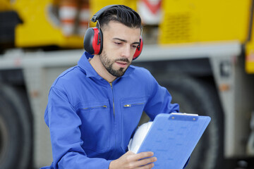 crane operator studying the clipboard