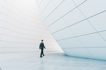 Man walking in abstract glass building open space interior.