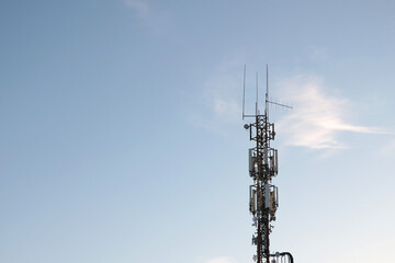 Cellular tower against the blue sky. Modern technologies.