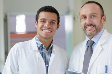 men in white coat smiling