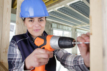 woman wearing helmet using different male work tools