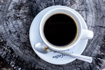 a cup of coffee on the wooden table