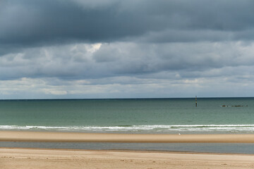 Fototapeta na wymiar low tide and storm clouds at Malo-Les-Bains beach in Dunkirk, france