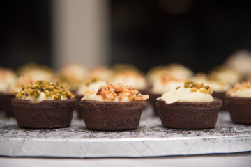 small mignon and single portion desserts. chocolate basket with cream and hazelnuts