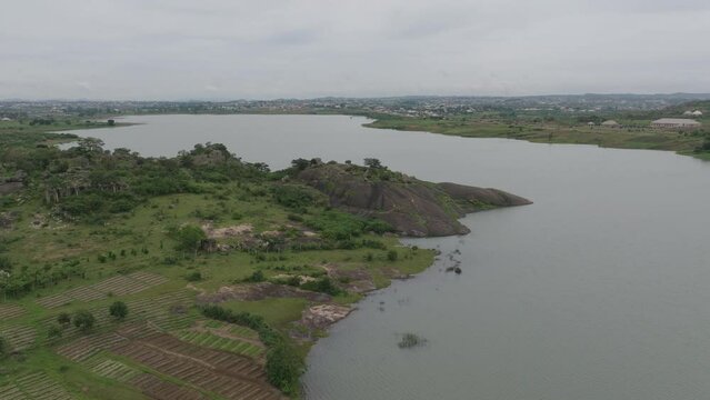 AERIAL - Lamingo Dam on a cloudy day, Jos Plateau, Nigeria, forward shot