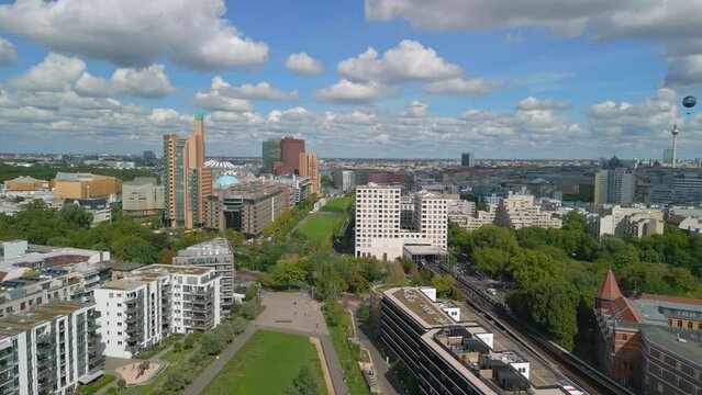 Beautiful aerial view flight panorama curved drone
of Potsdamer Platz on Tilla Durieux Park Berlin Germany at summer day 2022. 4k Marnitz Cinematic from above