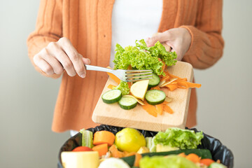 Compost from leftover food, asian young housekeeper woman hand holding cutting board use fork...