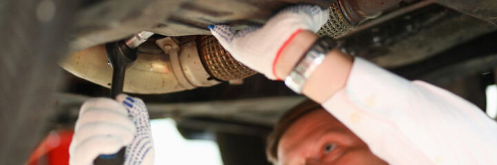 Auto mechanic repairs car suspension closeup. Car workshop services