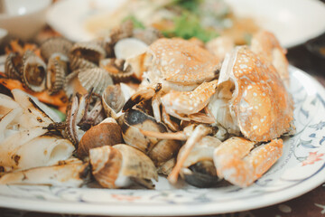 Grilled seafood set include cockle, crab, shrimp, squid and Spotted babylon. Close up