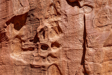 A suggestion of faces (pareidolia) in the weathered patterns of a rock wall in the Grand Staircase-Escalante National Monument, Utah, USA