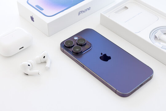 Madrid, Spain - September 20, 2022: Newly released iPhone 14 Pro, it's packaging box and Airpods Pro on white background