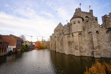 Fototapeta premium Gravensteen , medieval castle near leie river in old town of ghent dunring winter evening : Ghent , Belgium : November 30 , 2019