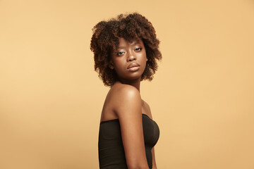 African american calm woman portrait with curly short hair. - Powered by Adobe