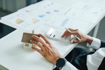 Bank staff at the Mortgage Department are working on paperwork and using a loan interest rate...