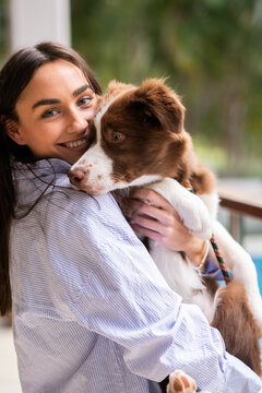 Young Woman With Border Collie Puppy