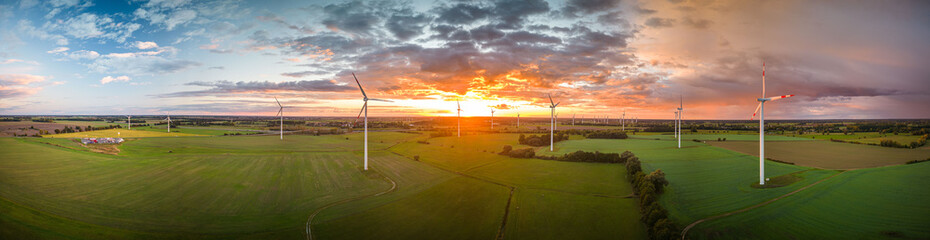 Aerial View of Windturbine against sunset with moody golden lighting