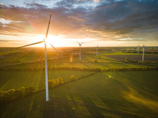 Aerial View of Windturbine against sunset with moody golden lighting