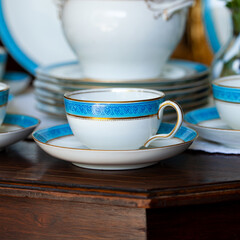 Antique British blue porcelain tea set. wedding table setting is richly decorated in luxurious interior. porcelain vintage service