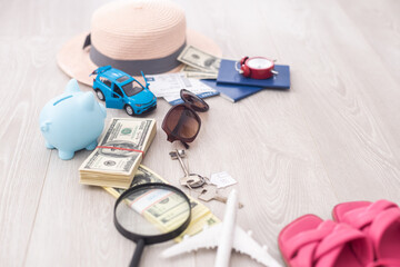 dollars, piggy bank, alarm clock, hat, glasses. Time to go on holiday. Things for summer trip.