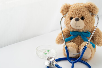 Children's doctor concept. Teddy bear toy, pills and stethoscope