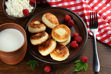 curd fritters and raspberries. Cheese fritters, pancakes or syrniki