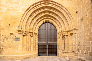 Fototapeta na wymiar Laguardia, Spain. August 5, 2022. Famous Portada de los Abuelos in Saint John Baptist church, medieval building that combines Romanesque and Gothic styles