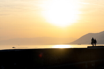 People enjoying Sunset in Camogli, a fishing village and tourist resort close to the peninsula of Portofino, on the Golfo Paradiso in the Riviera di Levante, in Genoa, Liguria, northern Italy