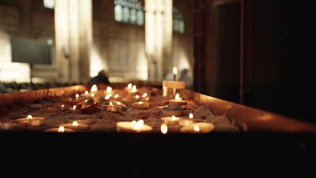 Slow motion candles lit for the death of Queen Elizabeth II inside Chester cathedral.